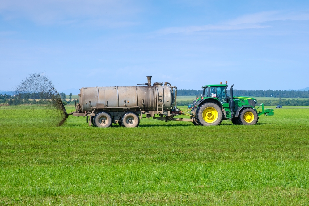 A,Big,Tractor,Spreading,Fertilizer,To,Improve,The,Harvest,On