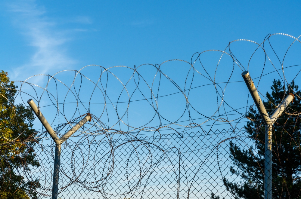 A,Close-up,View,Of,A,Tall,Barbed,Wire,Fence,On