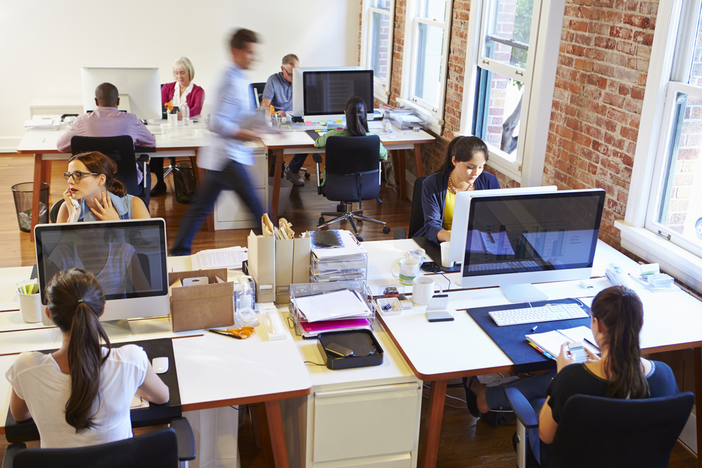 Wide,Angle,View,Of,Busy,Design,Office,With,Workers,At