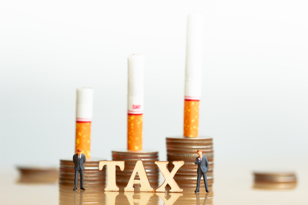Cigarettes,And,Coins,Stack.,Wood,Block,Word,Tax,And,Business