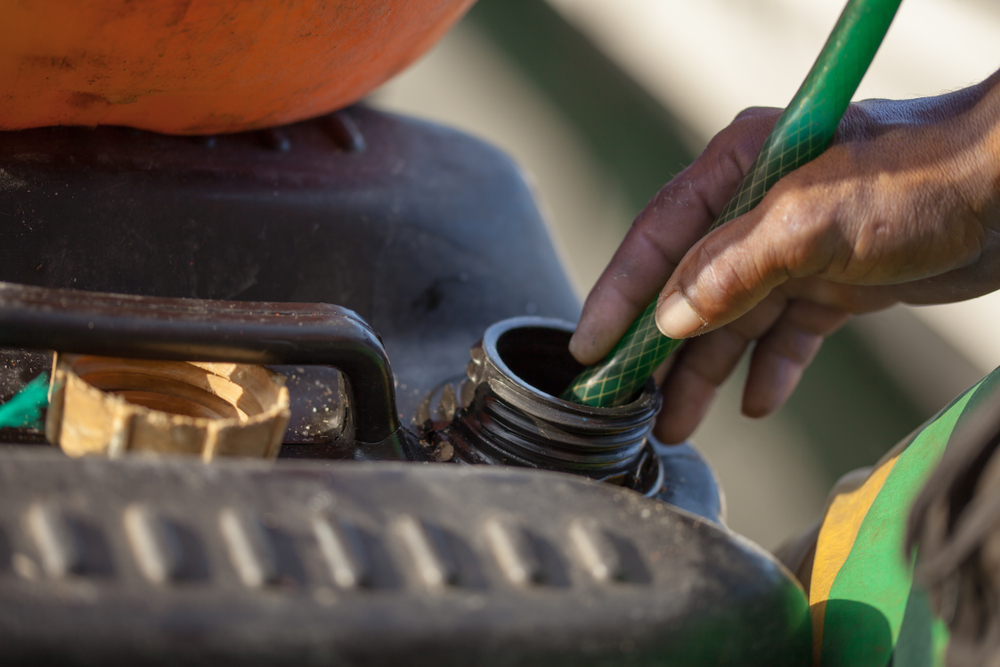 Hands,Of,A,Worker,Holding,A,Hose,That,Drives,Gasoline