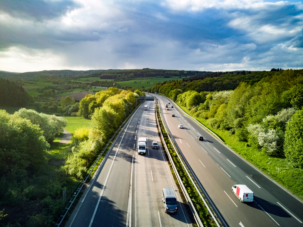 Highway,In,Germany,With,Cars,And,Sky,With,Big,Clouds