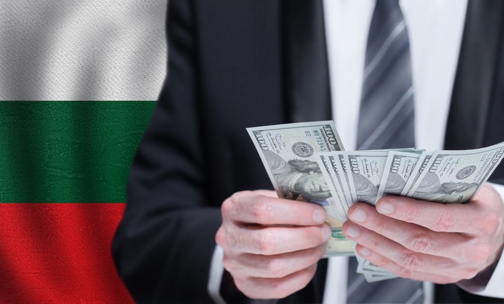 Hands,Holding,Dollar,Money,On,Flag,Of,Bulgaria