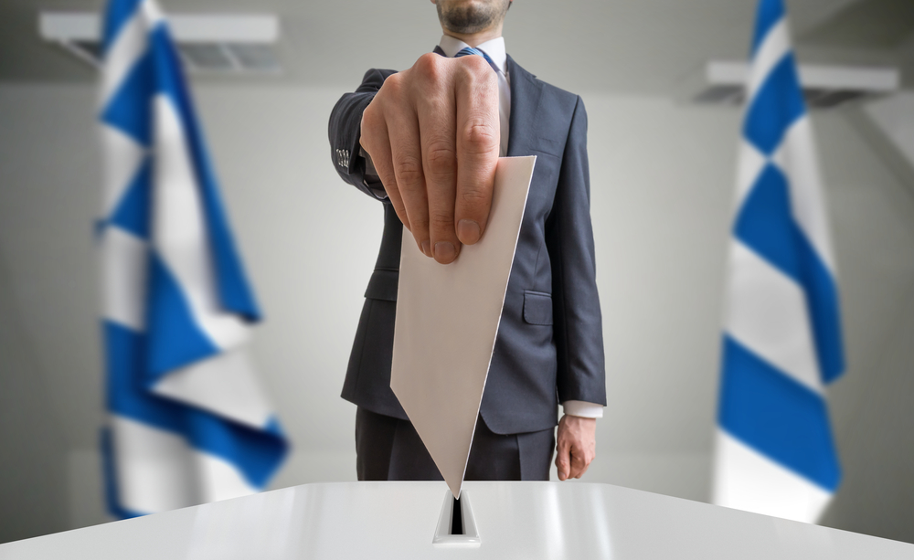 Election,Or,Referendum,In,Greece.,Voter,Holds,Envelope,In,Hand
