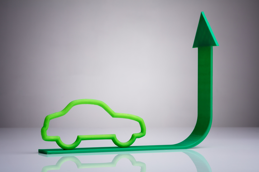 Blue,Car,Driving,On,Green,Upward,Arrow,Against,Gray,Background
