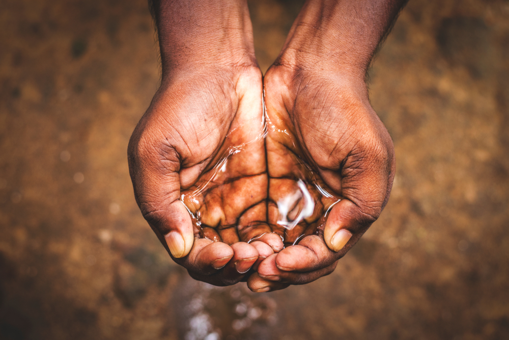 A,Man,Holding,Water,With,His,Hand,water,Crisis,In,India