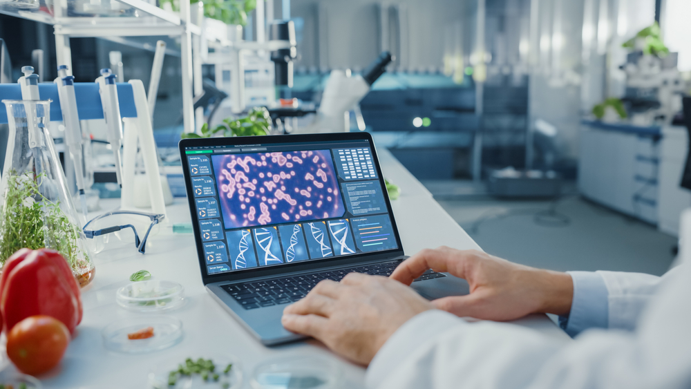 Male,Scientist,Working,On,A,Laptop,Computer,With,Display,Showing