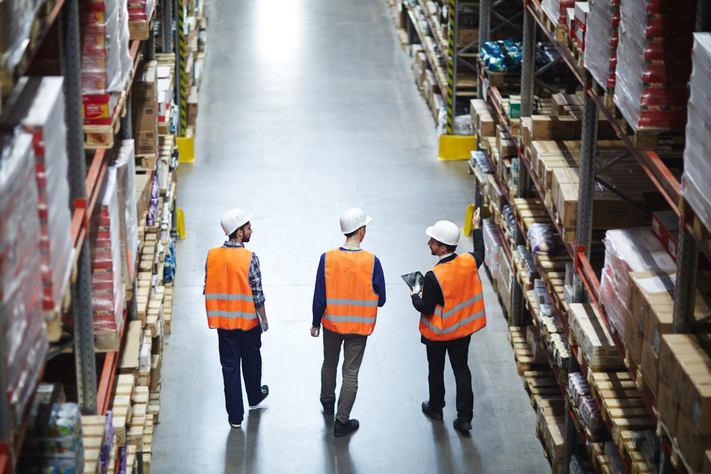 Group,Of,Warehouse,Workers,Wearing,Hardhats,And,Reflective,Jackets,Waking