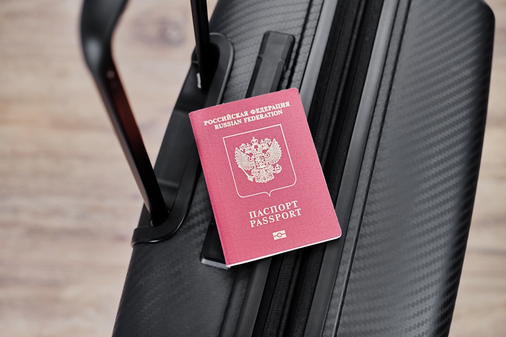 Russian,Passport,On,A,Black,Travel,Suitcase,,Top,View,,Selective