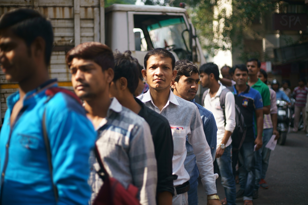 People/,Workers,Standing,In,Line,Outside,A,Construction,Site,For