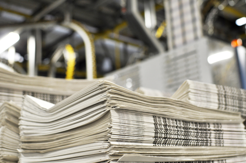 Stack,Of,Freshly,Printed,Daily,Newspapers,Transported,To,A,Printing