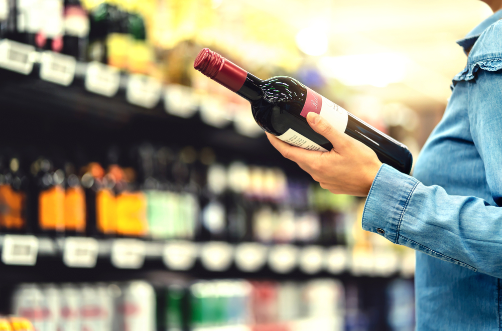 Alcohol,Shelf,In,Liquor,Store,Or,Supermarket.,Woman,Buying,A