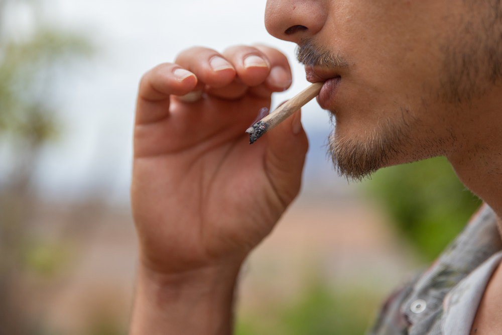 Close-up,Portrait,Of,A,Man,Who,Smokes,A,Joint,Of