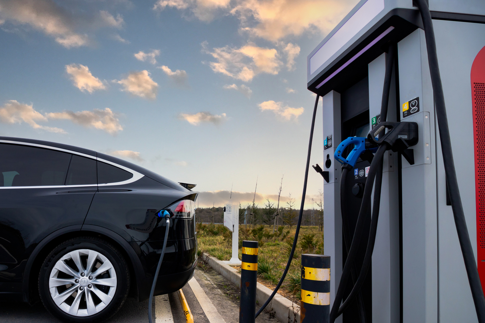 Ev,Car,Plugged,In,Charger,And,Ev,Charger,Station.,Electric