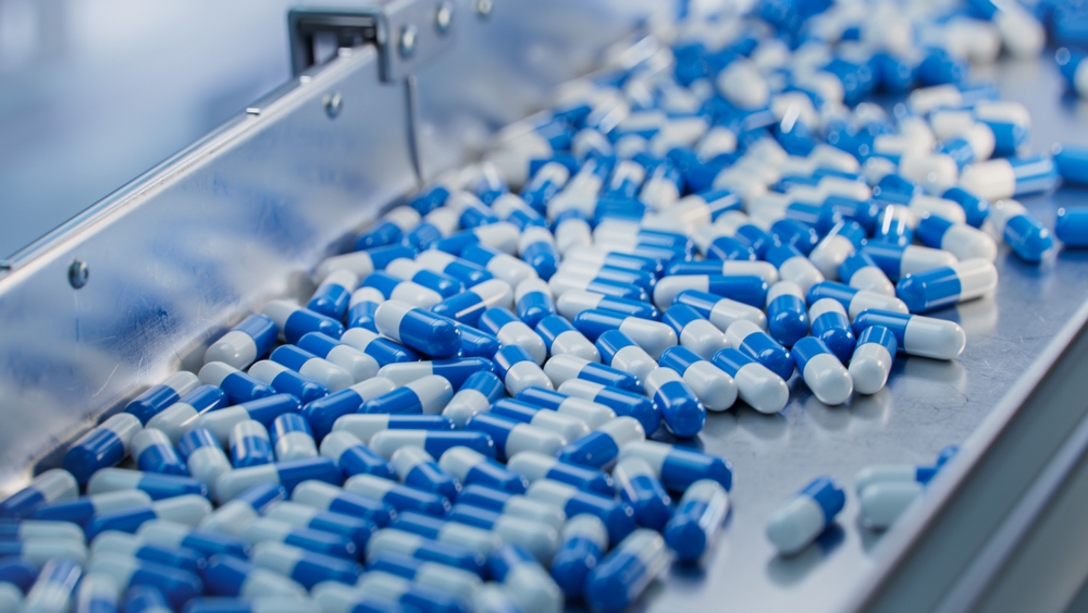 Blue,Capsules,Are,Moving,On,Conveyor,At,Modern,Pharmaceutical,Factory.