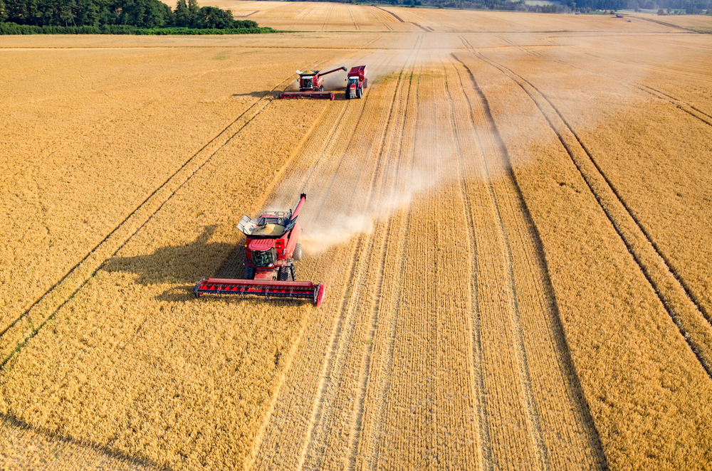 Aerial,View,On,The,Combines,And,Tractors,Working,On,The