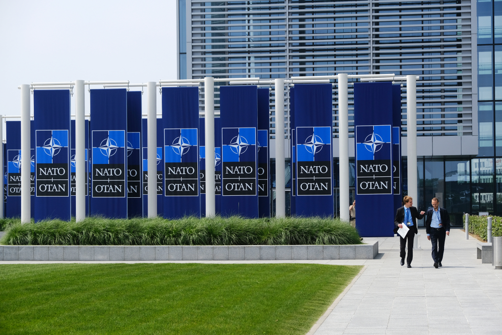 People,Walk,Outside,Of,The,Nato,Headquarters,In,Brussels,,Belgium,