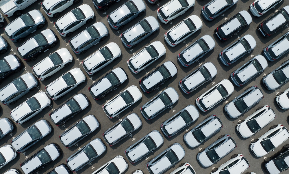 Aerial,View,Of,New,Cars,Stock,At,Factory,Parking,Lot.