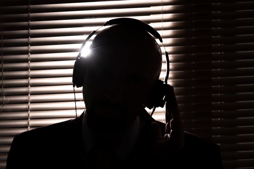Silhouette,Of,An,Fbi,Secret,Agent,,Listening,With,Headphones,And