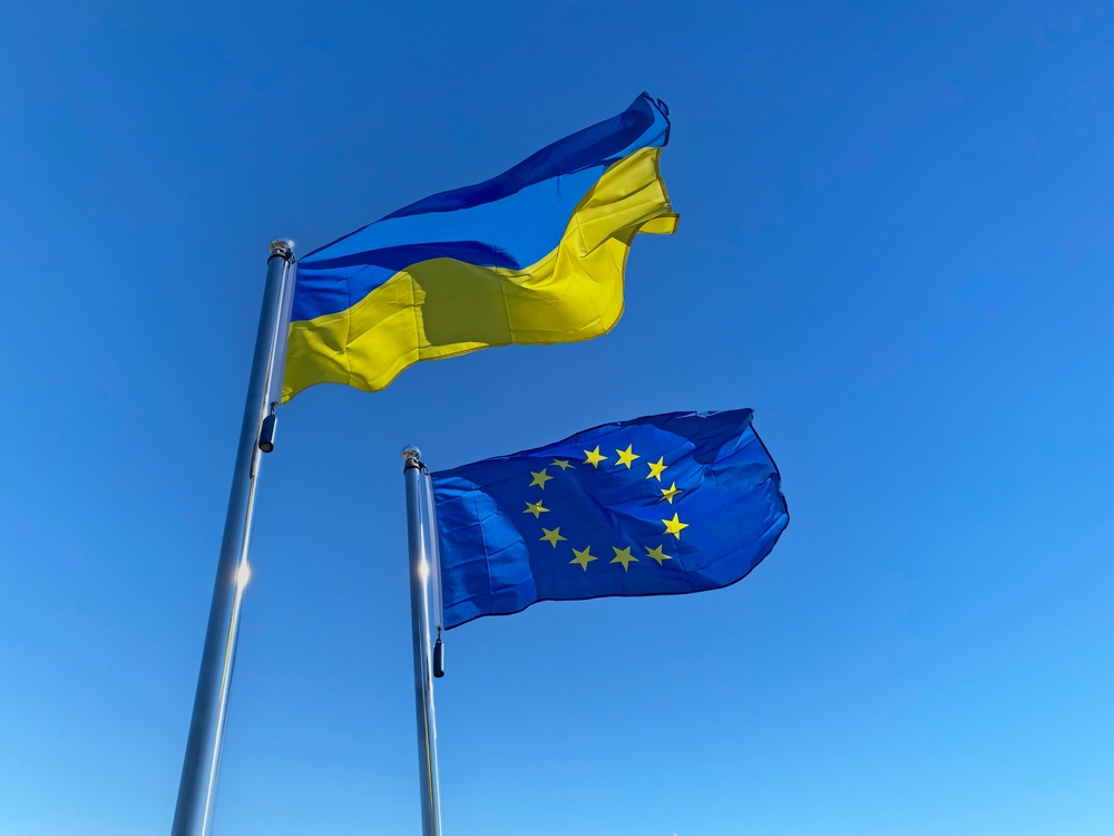 Ukrainian,And,European,Union,Flags,On,Flagpoles,Against,Blue,Sky