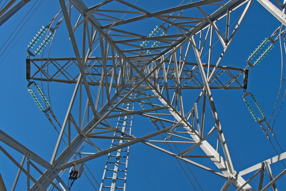 Detail,Of,Electricity,Pylon,Against,Blue,Sky
