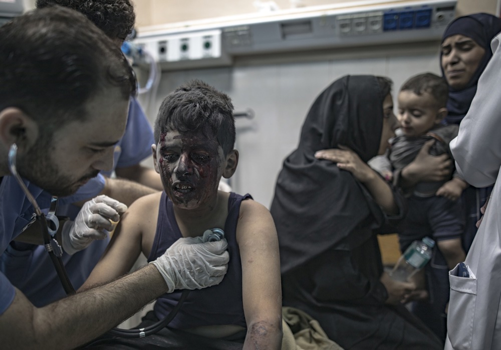 Palestinians search for bodies and survivors among the rubble of a residential building following an Israeli strike in Khan Younis