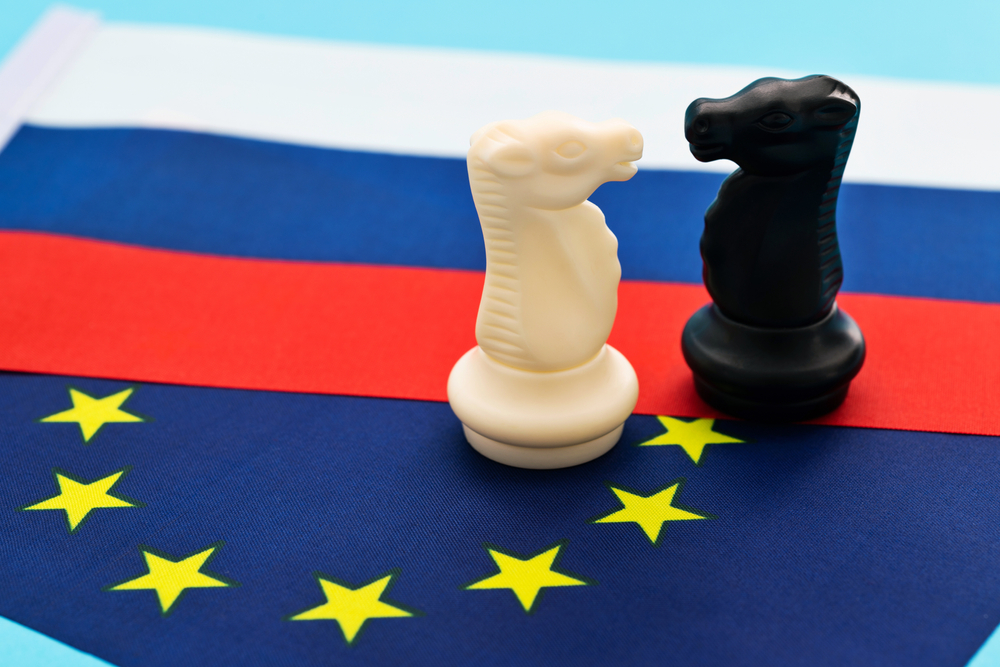 Two,Knights,Standing,On,Russian,Flag,And,Eu,Flag.