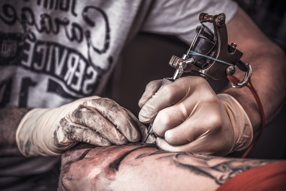 Professional,Tattooer,Burning,The,Tatoo,With,Gloves,On,By,Special