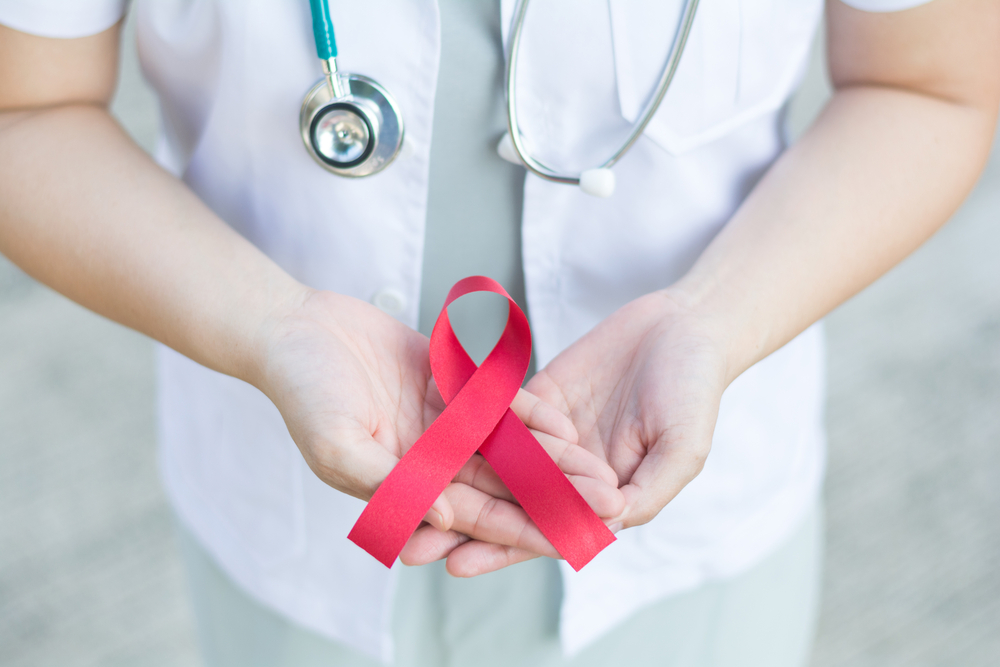 Female,Doctor,Holding,Red,Aids,Ribbon,On,Hand.national,Blood,Donor