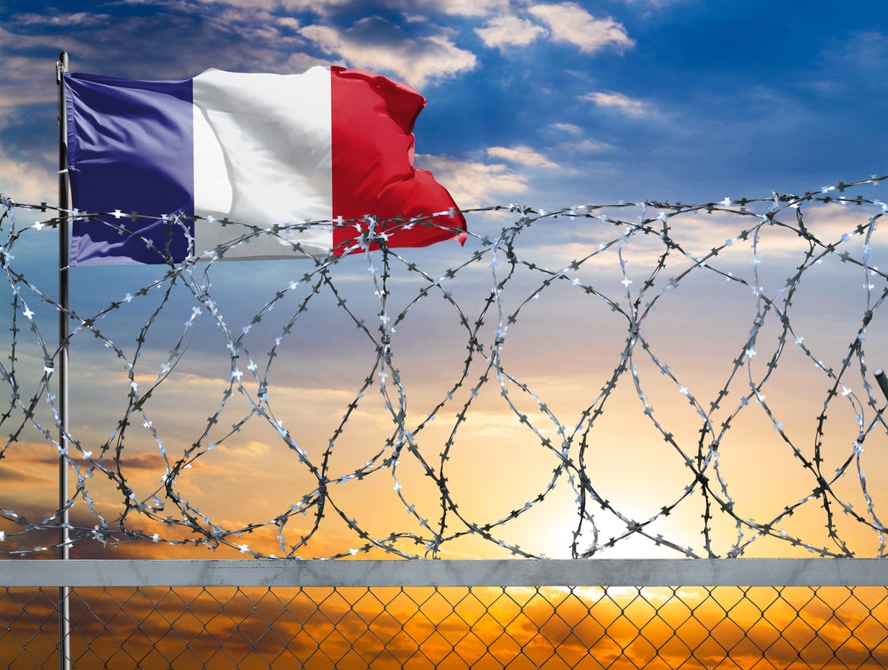 A,Fence,With,Barbed,Wire,Against,The,Background,Of,A