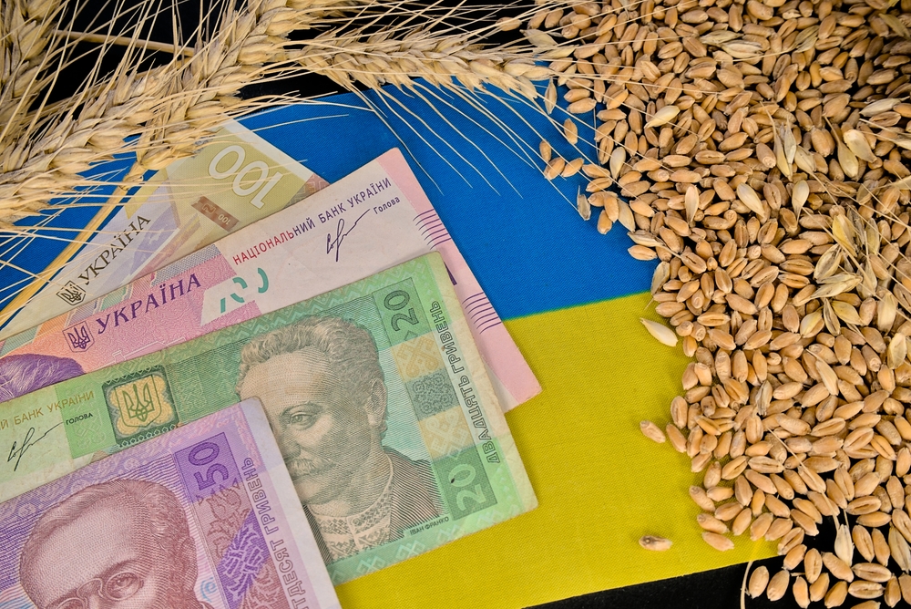 Ukrainian,Hryvnia,Banknotes,On,The,Flag,Of,Ukraine,And,Grains
