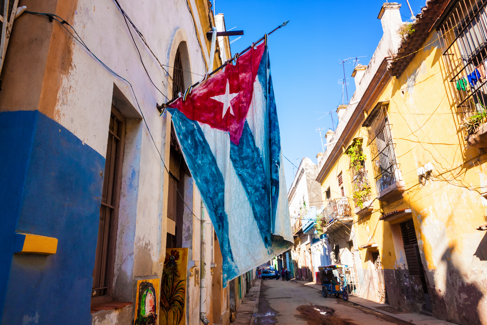 Street,Sidelined,By,Decaying,Buildings,In,Old,Havana,With,A