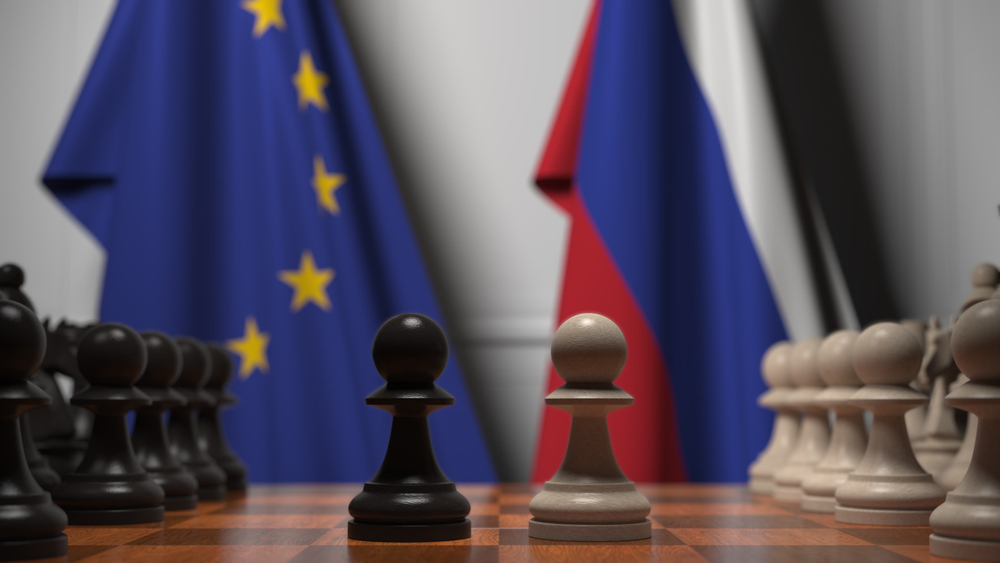 Flags,Of,The,Eu,And,Russia,Behind,Chess,Board.,The