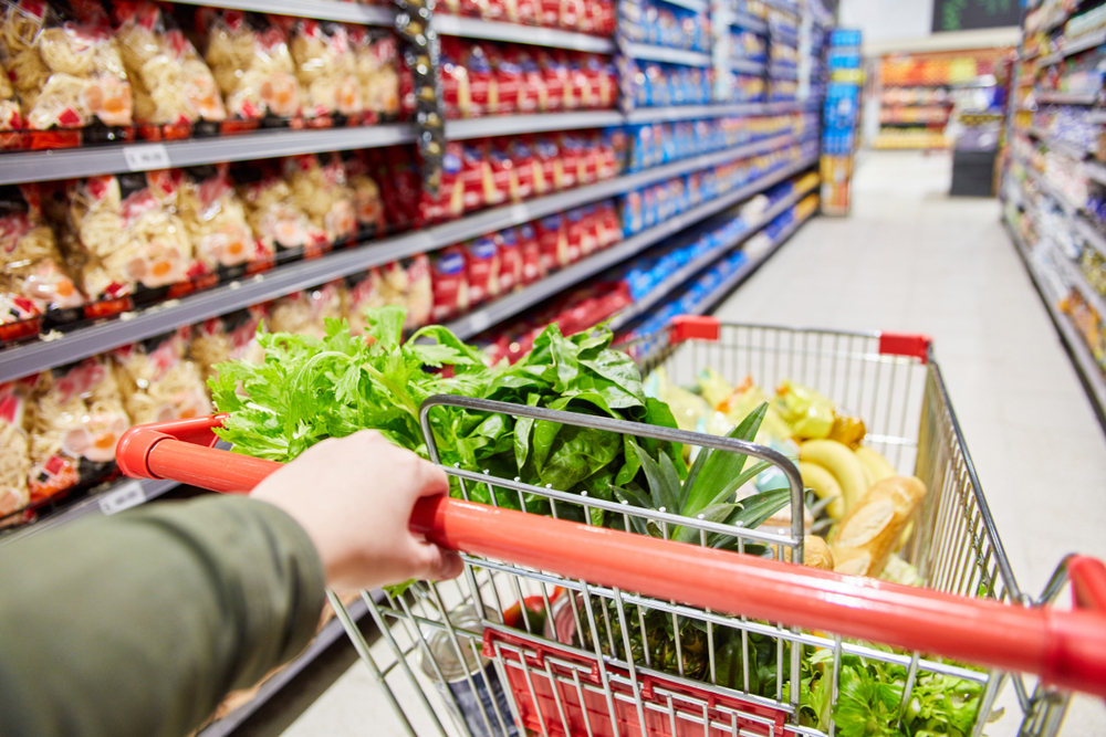 Customer,Pushes,Cart,With,Food,Through,A,Corridor,In,The