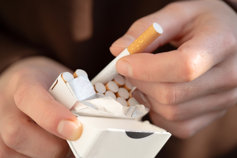A,Man,Holds,A,Pack,Of,Cigarettes,In,His,Hands,