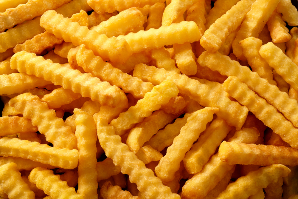 Close,Up,Background,Of,Crinkle,Cut,Crispy,Golden,Fried,Potato