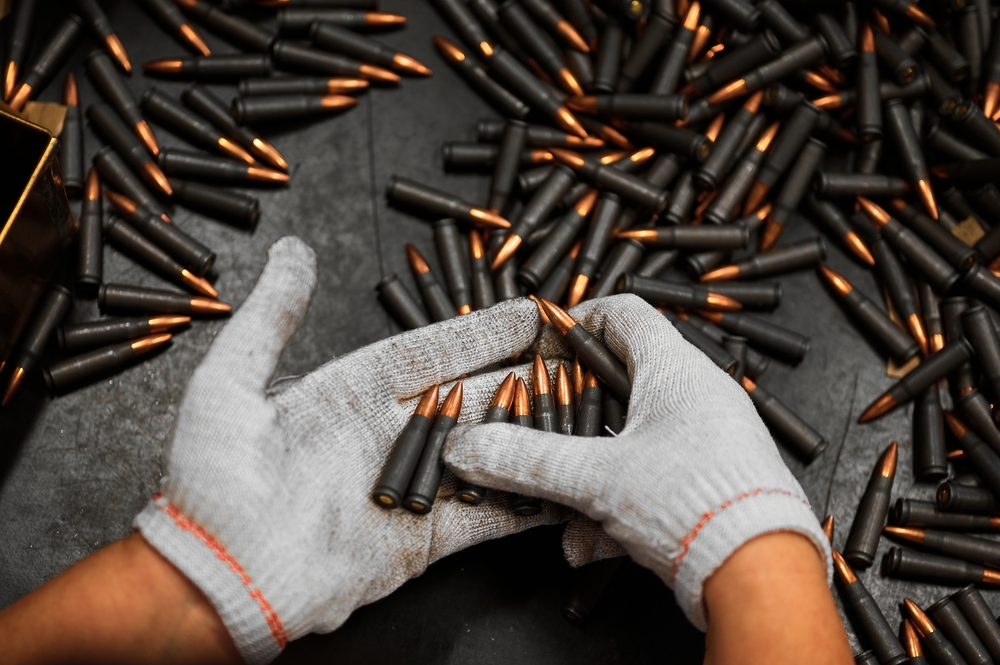 Employee,In,Gloves,Holds,Riffle,Cartridges,At,Workplace