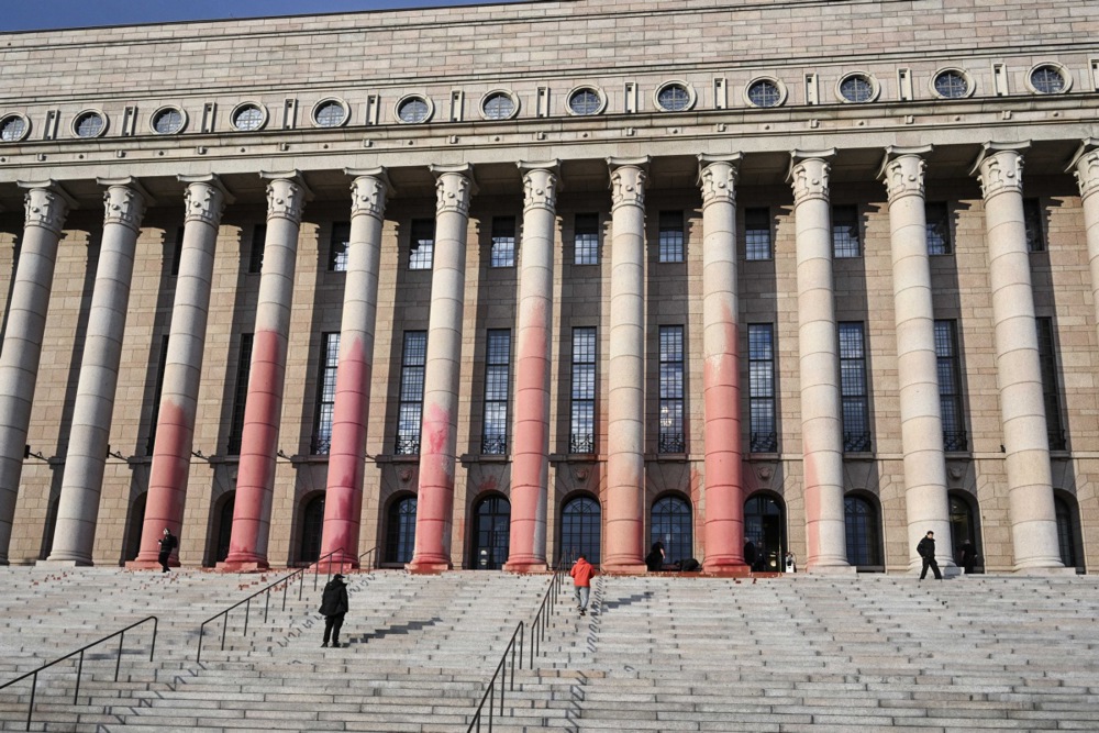 Environmental protesters splattered Parliament House in Helsinki with red paint