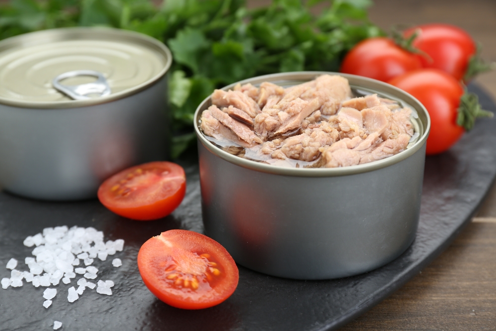 Tin,Cans,With,Canned,Tuna,,Salt,And,Tomatoes,On,Wooden
