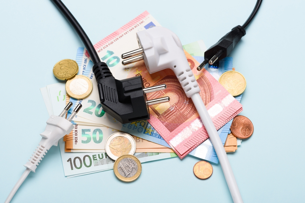 Electric,Power,Plugs,On,Euro,Banknotes,On,Blue,Background.,Concept
