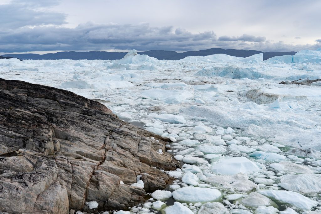 Ice-choked fjord and Proterozoic gneiss at Ilulissat Ice fjord, Ilulissat, Greenland